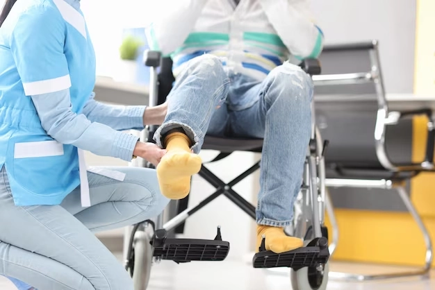 rehabilitation-doctor-helping-lift-leg-patient-wheelchair-recovery-from-injuries-concept_151013-18200